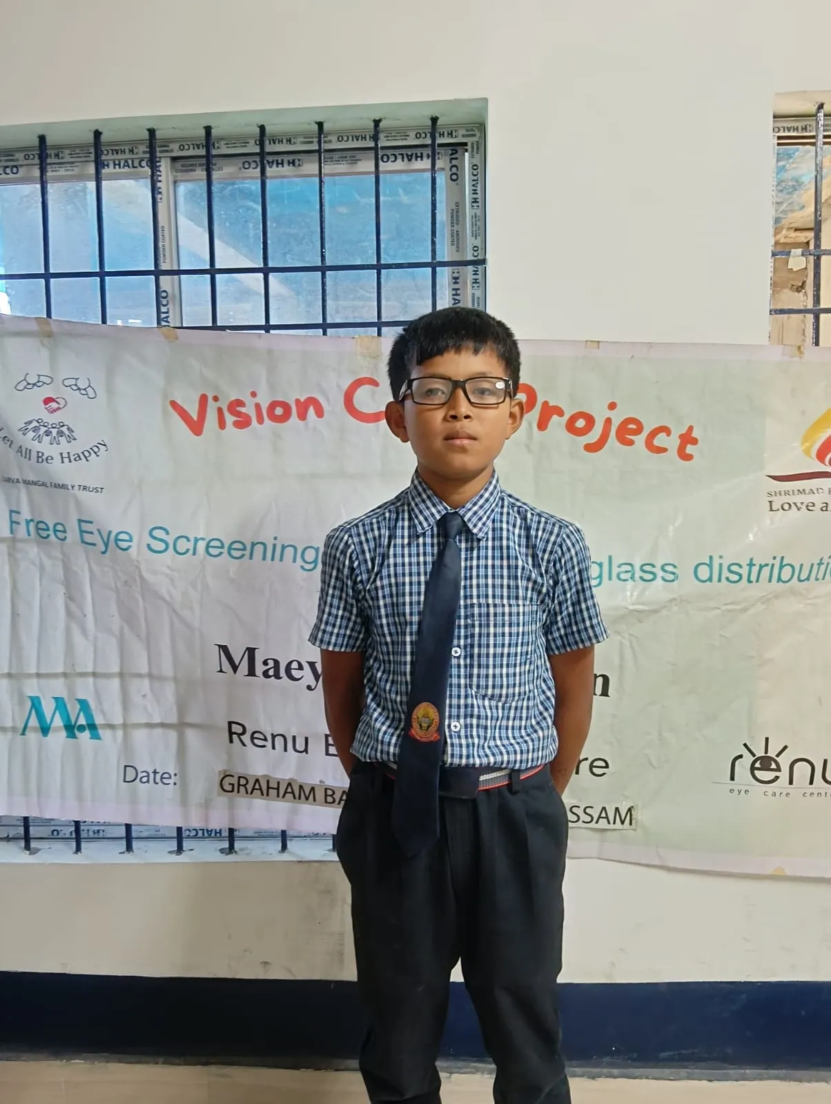 Optometrist examining a student's vision using specialized charts.